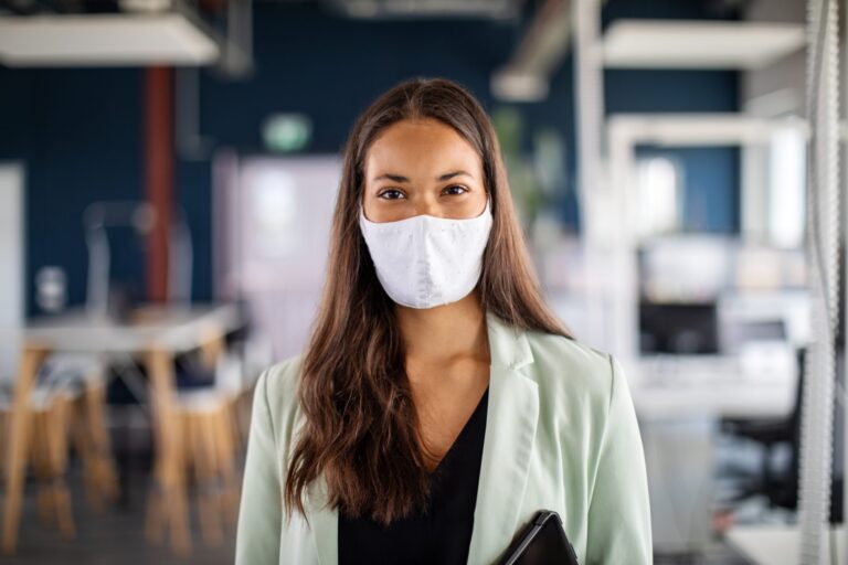 portrait of a businesswoman with face mask in office